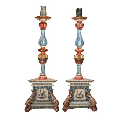 pair of painted candlesticks with a bird on top of them