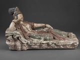 a statue of a man sitting on top of a rock