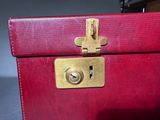 a close up of a red suitcase with a lock