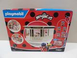 a box of playmobil with a picture of a ladybug shop