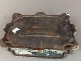 an old metal box with a tag on it