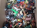 a box full of assorted toy animals in it