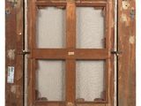 a close up of a wooden window with a glass pane