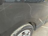 a car that has been painted black in a parking lot