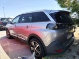 a silver car that is parked in a parking lot