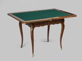 a small table with a green top and gold legs