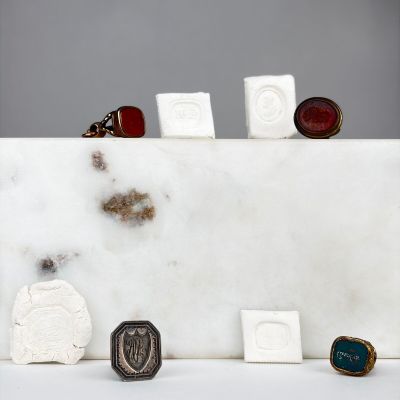 several different rings and rings are sitting on a white marble block