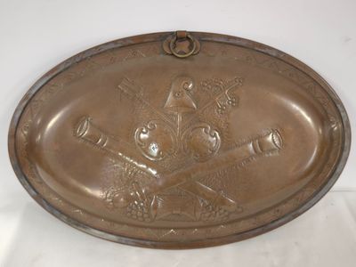an old brass plate with a picture of a man holding a baseball bat