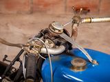 a close up of a motorcycle handlebars on a blue motorcycle