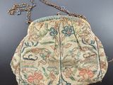 an old purse with a chain hanging from it ' s side on a table