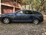 a picture of a blue car parked in front of a house