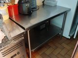a small kitchen with a metal counter and a blender