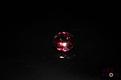 an image of a pink crystal ball on a black surface