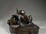 an image of a bronze statue of a man and a woman on a horse