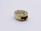 an image of a close up of a gold colored pill case