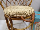 a wicker chair with a basket on top of it