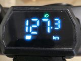 a digital clock on the handlebar of a bike