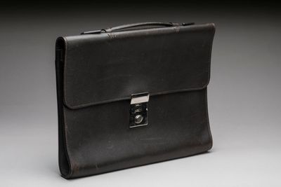 a black briefcase sitting on top of a white table