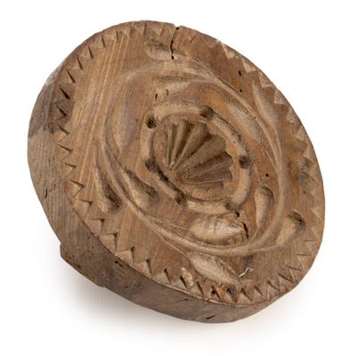 an old wooden object on a white surface with a white background