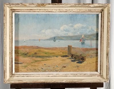 a picture of a painting on a easel by the water