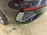 a close up of a car ' s tail light with a sticker on it