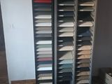 a room that has a bunch of shelves with different colored papers