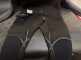 a black wet suit sitting on top of a car seat