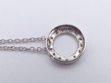 a close up of a necklace on a white surface with a chain