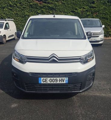 la camionnette blanche est garée dans le parking à côté d'autres voitures