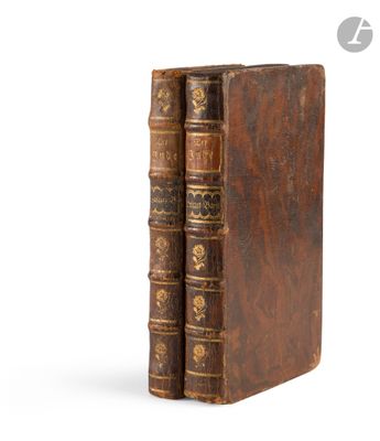 an old pair of books sitting next to each other on a white surface