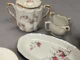 a table with a plate, bowl, cup, and saucer on it