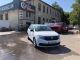 a white car parked in front of a building in a parking lot