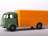 an orange and green toy truck on a white surface