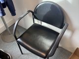 a chair and a skateboard in the corner of a room