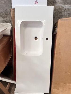 a white sink and a brown chair in a room