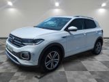 a white volkswagen suv is parked in a room with a checkered floor
