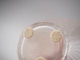 a close up view of a glass of liquid with a smiley face on it