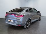 the rear view of a grey car in a showroom