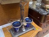 a tray with blue cups on it sitting on a dresser