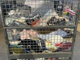 a metal cart with many items in it in a warehouse