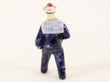 a small figurine of a man with a hat on