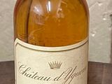 a bottle of whiskey sitting on a table next to a bottle of wine