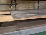 a man that is standing next to a table with a skateboard on it