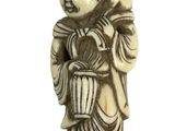 statue of a man holding a basket and a bird on his shoulder