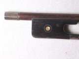 a violin bow that is laying on a white surface