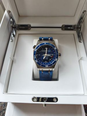 a blue watch in a white box on a table