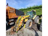 a tractor that is parked next to a dump truck