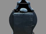 a small metal box with a lid sitting on a stand