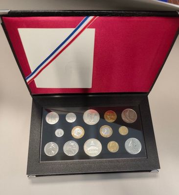 an open box of coins with a flag on it