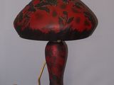 a red and black lamp that is on a table